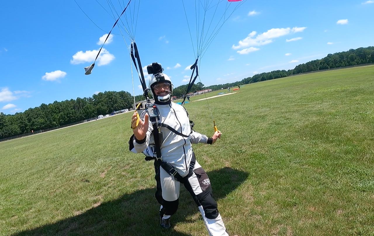 Man lands parachute from a skydive and high-fives 