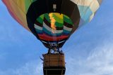 hot air balloon carrying skydivers at lift off