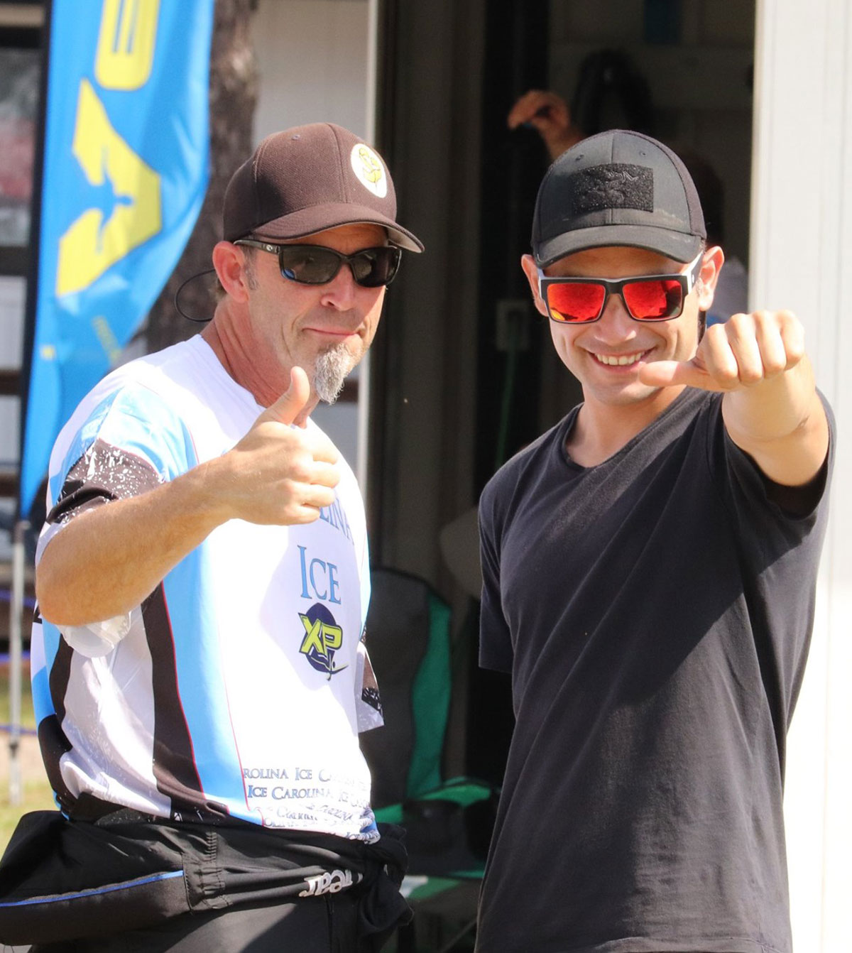 Skydivers give thumbs up on ground 